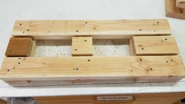 A wooden box

Description generated with high confidence